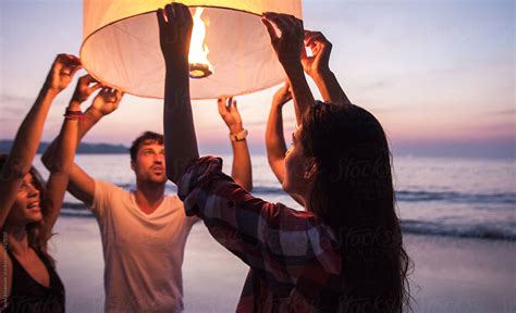 Group Of Friends Releasing A Lantern At The Beach In Thailand By Jovo Jovanovic