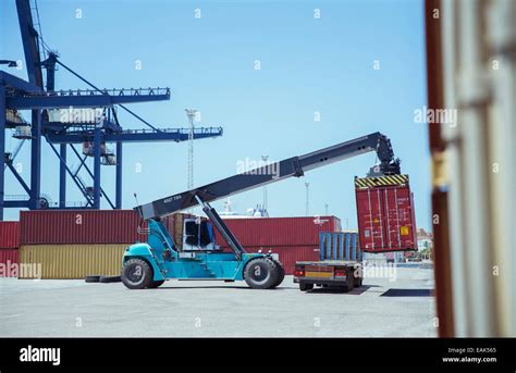 Crane Lifting Cargo Container Onto Truck Stock Photo Alamy