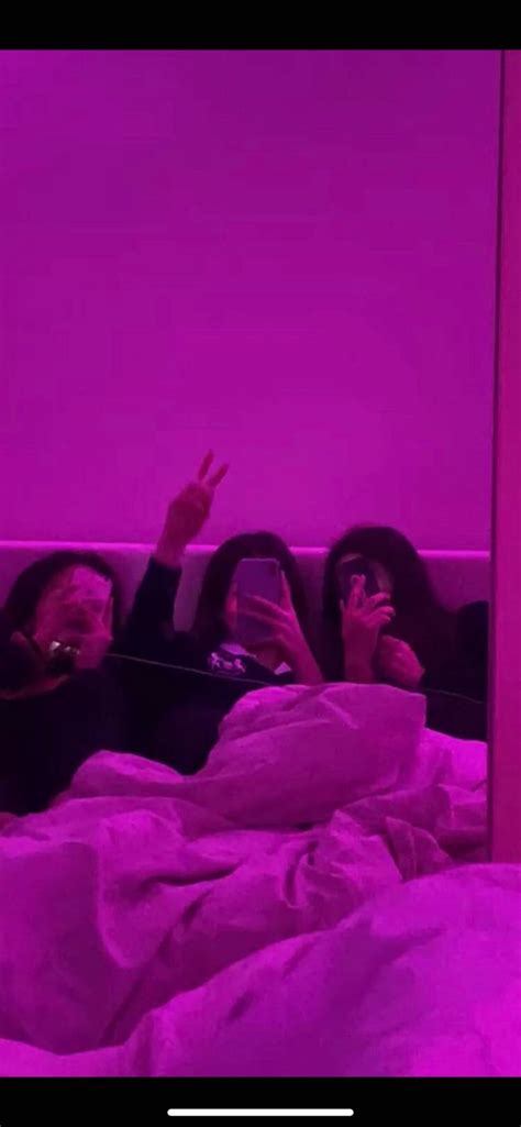 Two People Laying In Bed With Their Cell Phones Up To Their Ears And One Person Taking A Selfie