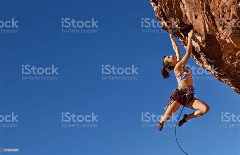 Female Climber Clinging To A Cliff Stock Photo Download Image Now