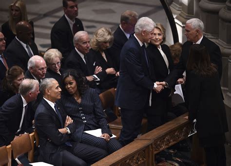 video george w bush appears to sneak michelle obama candy at george hw bush s funeral abc7