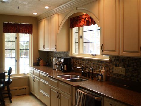 Elegant and simply styled arched cabinet valances add a decorative accent and focal point to your kitchen. Custom Omega cabinetry in an Opaque finish. Bumped out ...