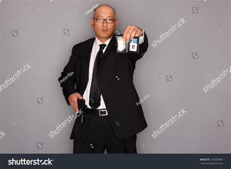 Fbi Agent With Gun And Holding A Badge Stock Photo 103609985