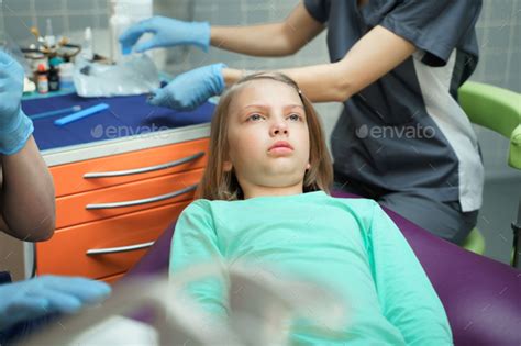 Little Scared Girl Sitting In Chair In Dentist Doctor Office Kidchild