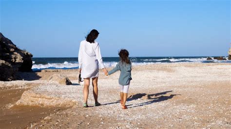 Mother With Daughter Is Walking On The Beach Together Stock Image Image Of Ocean Young