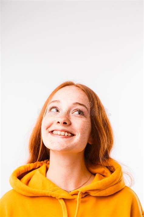 Portrait Of An Emotional Red Haired Girl With Freckles And Braces On A