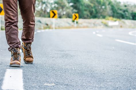 Photo Of Person Walking On Road · Free Stock Photo