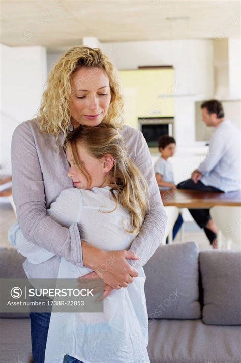 Mother Hugging Her Daughter And Smiling Superstock