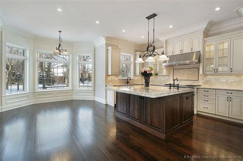 Dark wood cabinets are a timeless option to own in every type of kitchen, either modern or with a classic design. 40 Kitchens With Large or Floor-To-Ceiling Windows
