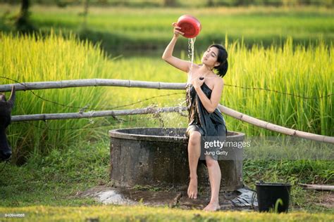 Rural Girl Is Taking A Shower From A Traditional Groundwater Pond At