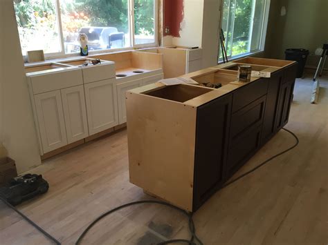 Update your whole kitchen look by painting, staining and refacing your kitchen cabinetry. Painted Kitchen with Stained Island Cabinets. Cabinets by ...
