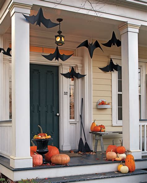 A Porch Decorated For Halloween With Bats And Pumpkins