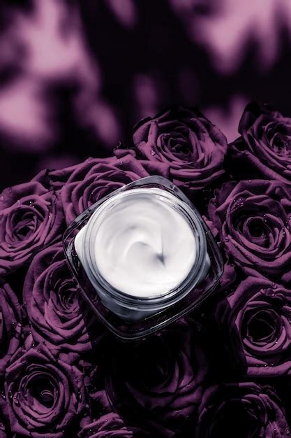 Premium Photo Face Cream Skin Moisturizer On Purple Roses Flowers
