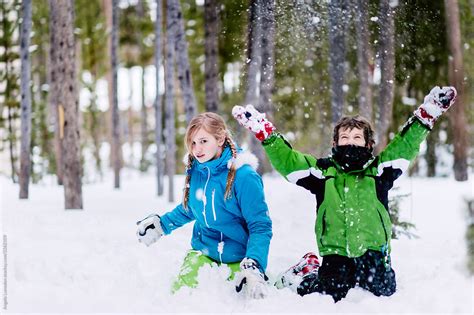 Children Playing In Deep Snow In Winter By Stocksy Contributor