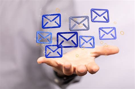 3d Rendered Electronic Mail Hovering In Mans Hand Stock Photo
