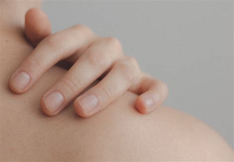 Close Up Photo Of Person Touching Their Shoulder · Free Stock Photo