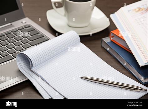 Notepad Pen Books Laptop And Cup Of Coffee On Dark Wooden Office