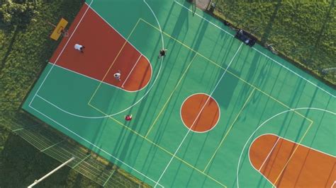 People Are Playing Basketball On Court Aerial Vertical Top Down View