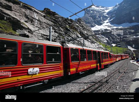 A Red Jungfrau Railways Train At The Eigergletscher Station With The