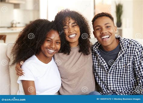 African American Teen And Young Adult Brother And Sisters Smiling To
