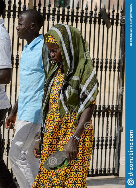 Unidentified Senegalese Woman In Colored Traditional Clothes Wa