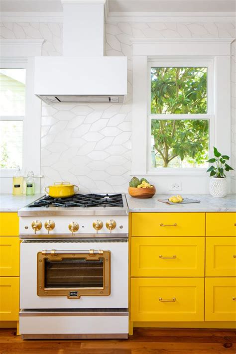 For backsplash ideas, yellow gold mixed tones usually used to create the transition between countertop to cabinets. 25 Yellow And White Kitchens That Raise The Mood - DigsDigs