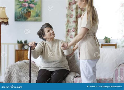 Nurse Helping Elderly Woman To Stand Up Stock Image Image Of