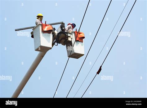 Electricians Work Together On The Electric Cable Car And Electric Pole