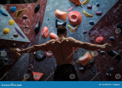 Athletic Man Stretching Before Climbing In A Bouldering Gym Stock Image