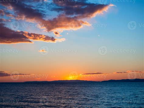 Beautiful sunset over cool blue sea - islands and mountains on the