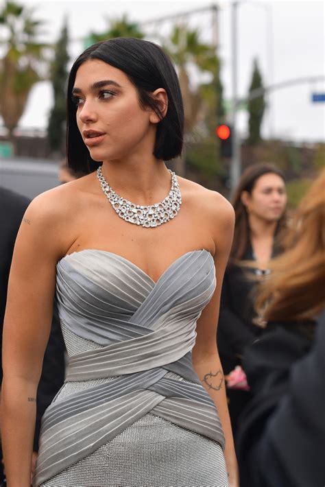 She rocked her silver sheer dress which featured a. Dua Lipa Photos Photos - 61st Annual Grammy Awards - Red ...