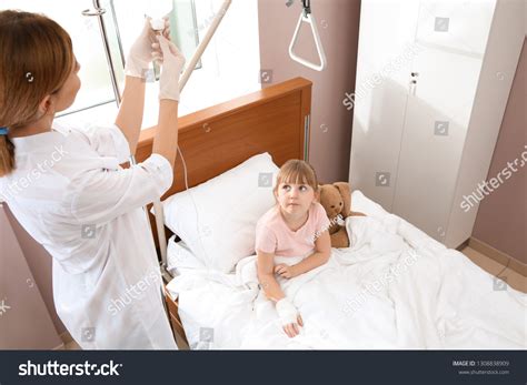 Doctor Adjusting Intravenous Drip Little Child Stock Photo 1308838909