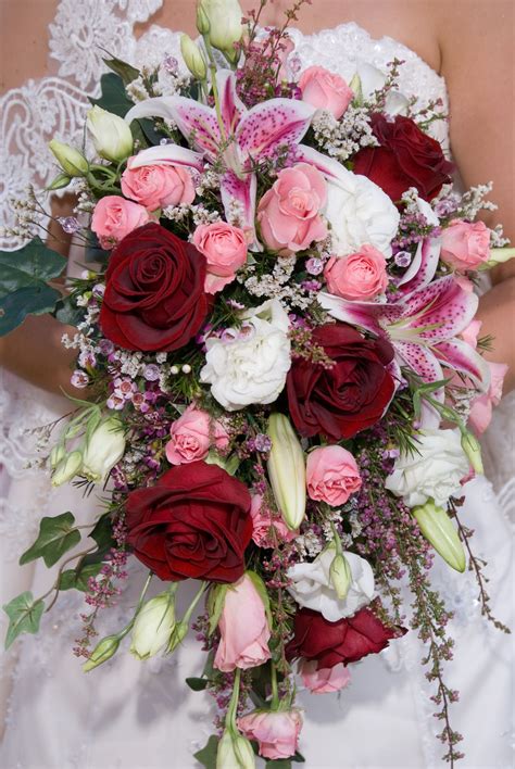 traditional cascade bridal bouquet of pink roses pink heather stargazer lilies white