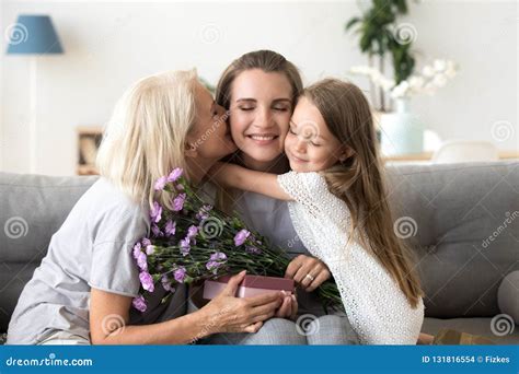 Little Daughter And Old Mother Kissing Embracing Congratulating Stock