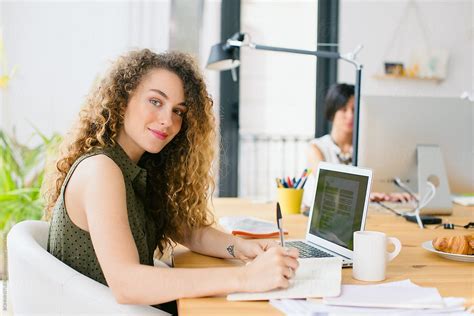 Female Entrepreneur Working On A Laptop In A Beautiful Studio Del