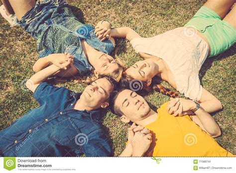 Friends Lying And Relaxing On The Grass Stock Photo Image Of Group Friendship