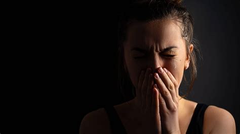 Sad Desperate Grieving Crying Woman With Folded Hands And Tears