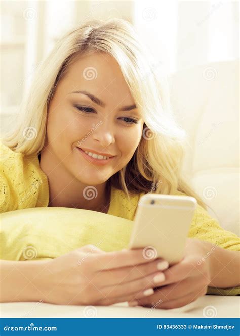 Happy Blonde Girl With A Smartphone At Home Stock Image Image Of