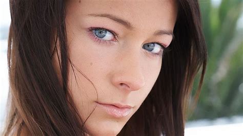 A Woman With Blue Eyes Is Posing For The Camera
