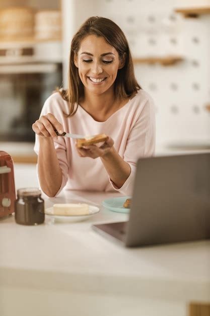 Premium Photo Shot Of A Young Smiling Woman Preparing Breakfast For