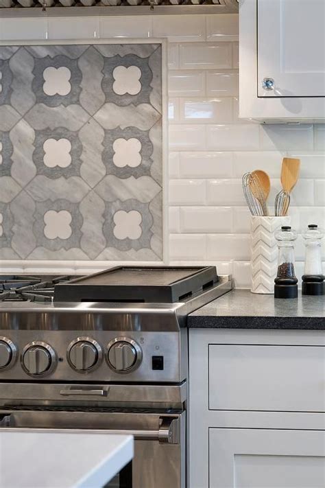 Gorgeous Quatrefoil Mosaic Cooktop Tiles Framed By White Beveled Subway