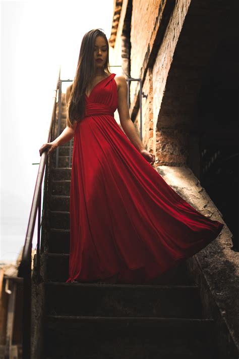 Woman Wearing Red Dress Standing On Staircase · Free Stock Photo