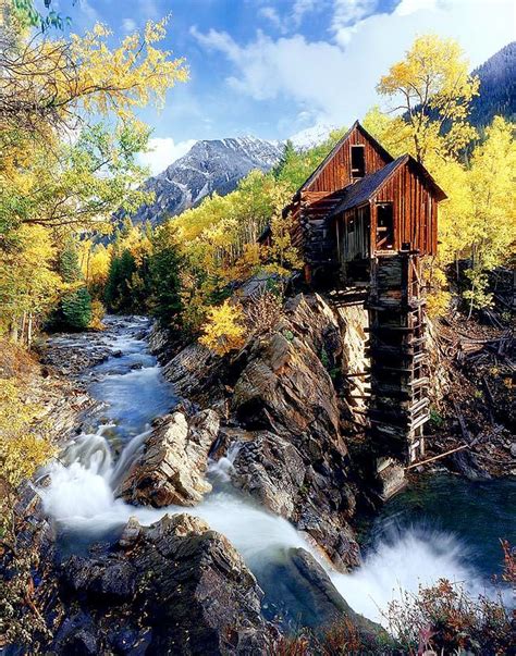 Dilapidated Log Cabin Atop A Cliff In The Mountains By A Rivermaybe