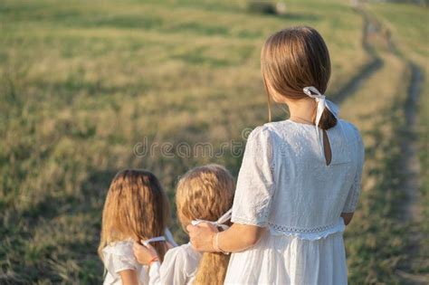 A Gentle Mother With Two Daughters In Nature Mom Braids Beautiful Hair
