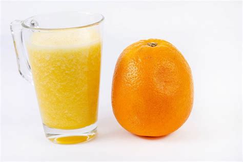Mixed Orange Juice With Whole Orange On The White Table Flip 2019