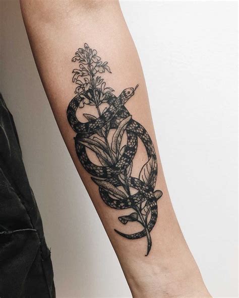 Snake Wrapped Around A Flower Tattoo Inked On The Left Forearm By