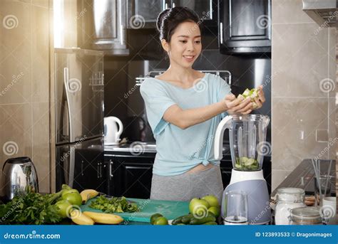 asian woman putting fruits in blender stock image image of attractive home 123893533