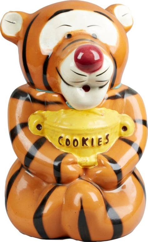 A Ceramic Cookie Jar Shaped Like A Tiger Holding A Bowl With The Word Cookies On It