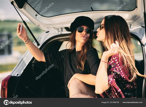 Two Women Taking Selfie While Sittink Trunk Road Rtip Concept — Stock