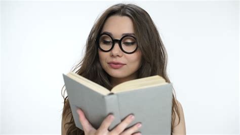 Beautiful Young Brunette Girl In Nerd Glasses Reading A Book Stock